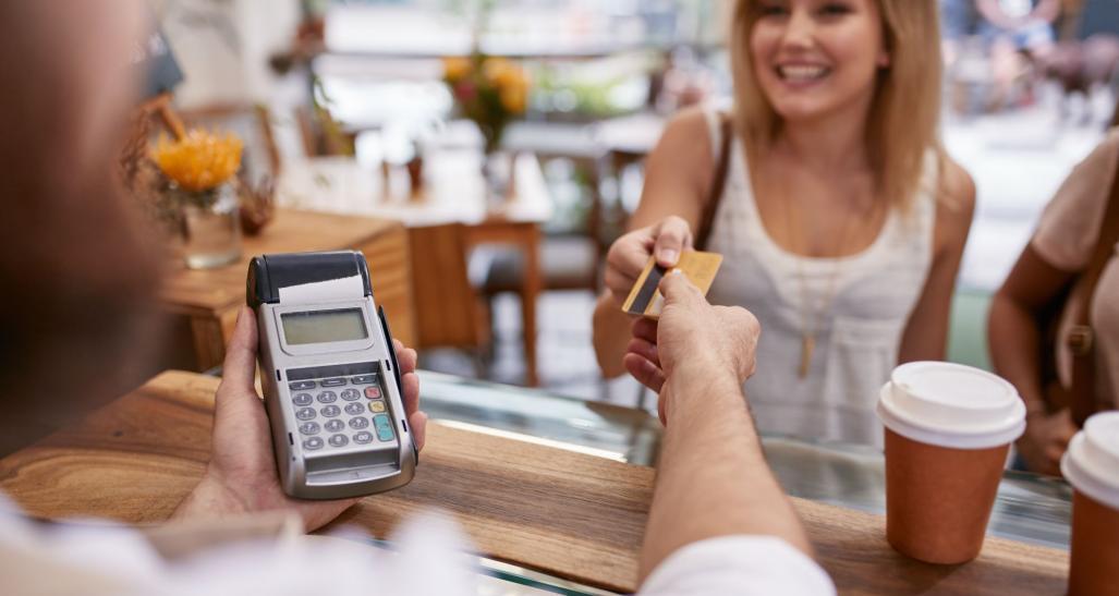 A woman paying with credit card.
