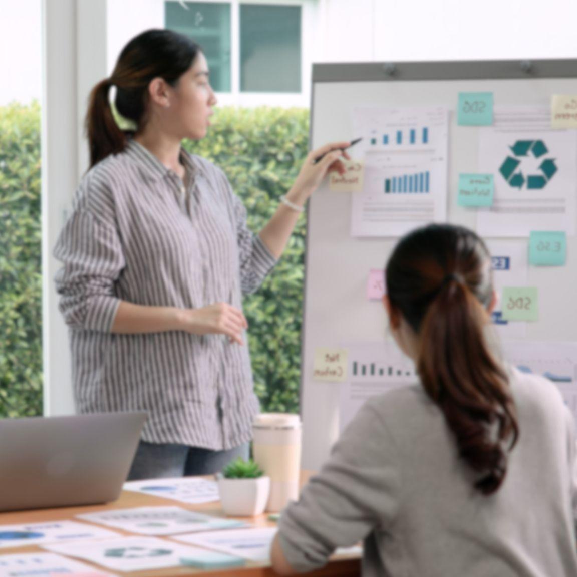 A woman presenting in a meeting.