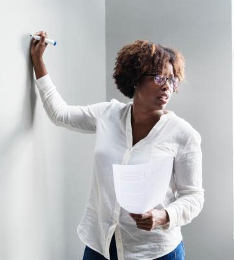 Woman writing on whiteboard