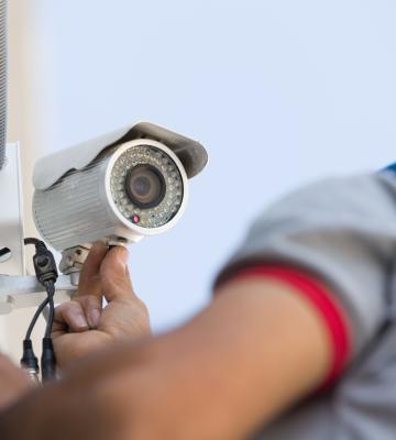 a man installing security camera