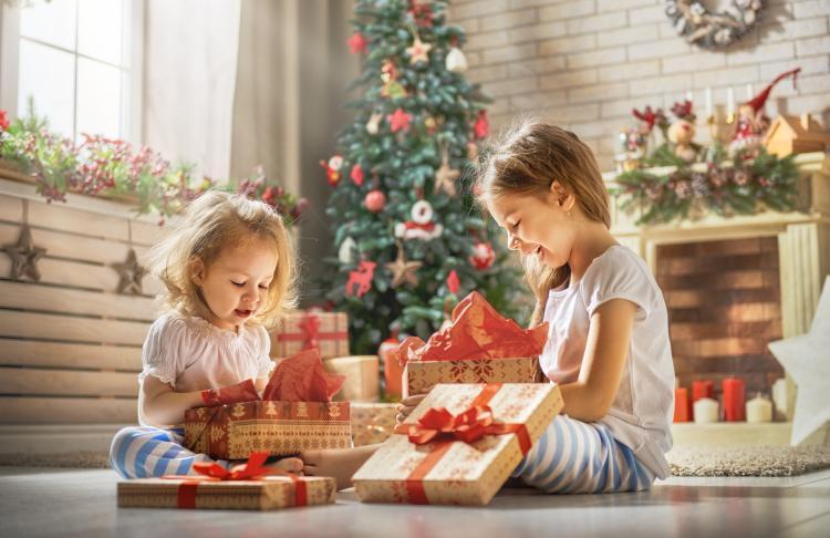 Children opening holiday gifts.