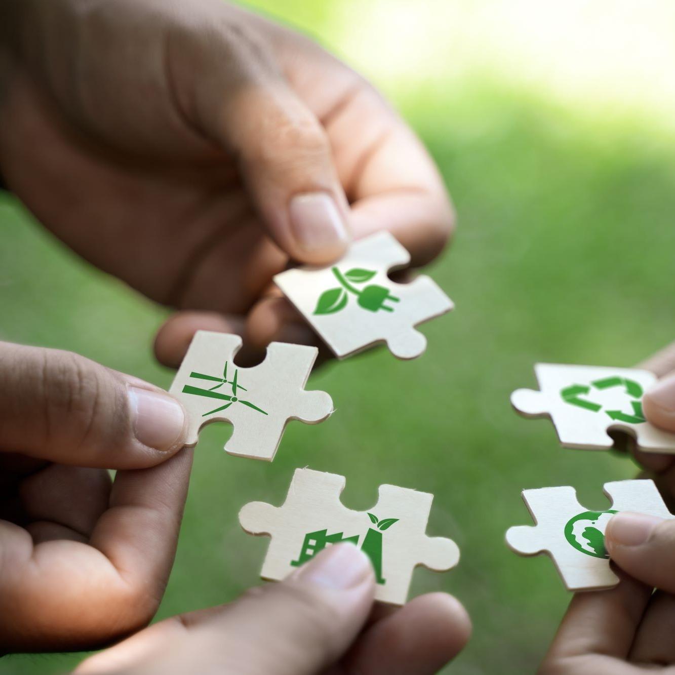 Puzzle peices with sustainability symbols.